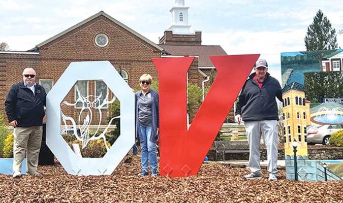 Town of Wise officials pose beside the municipality’s new LOVE sign, unveiled Sunday.   LISA MAINE PHOTO