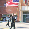 Vietnam veteran Tommy Fannon carries the flag Wednesday during a Loyalty Day parade in Coeburn.  KENNETH CROWSON PHOTO