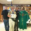 Members of Coeburn VFW Post 8652 presented a certificate to Danny Nauss of Wise, who joined his four brothers in earning Eagle Scout rank. Pictured are VFW members John Clupp and Anthony Willis at left and second from right, Nauss, and Father Eric Assamoah, pastor at St. Anthony Catholic Church where Nauss is an altar server.