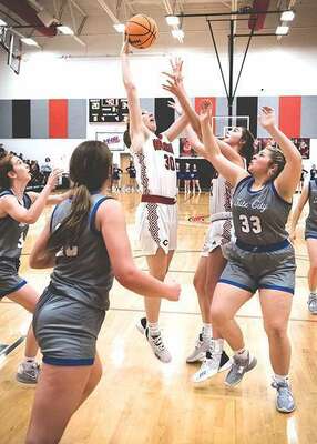 Central’s Gracie Tompkins secures the rebound for the Lady Warriors. PHOTO BY ROBERT PRICE