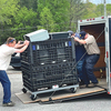 Tyler Surber, Jesse Whiffen, Greg Cross, Jason Grimes and Zackary Tyler work together to load a container of electronic waste into a trailer.  LISA MAINE PHOTO