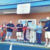 The Wise County Chamber of Commerce, St. Paul officials and others cut the ribbon May 10 to welcome Mini Cake Co. to town.  CHAMBER OF COMMERCE PHOTO